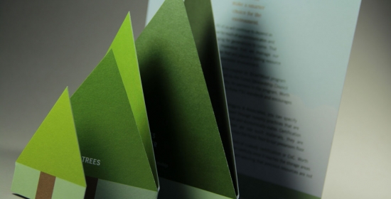 An accordion folded row of trees grows progressively larger in a brochure